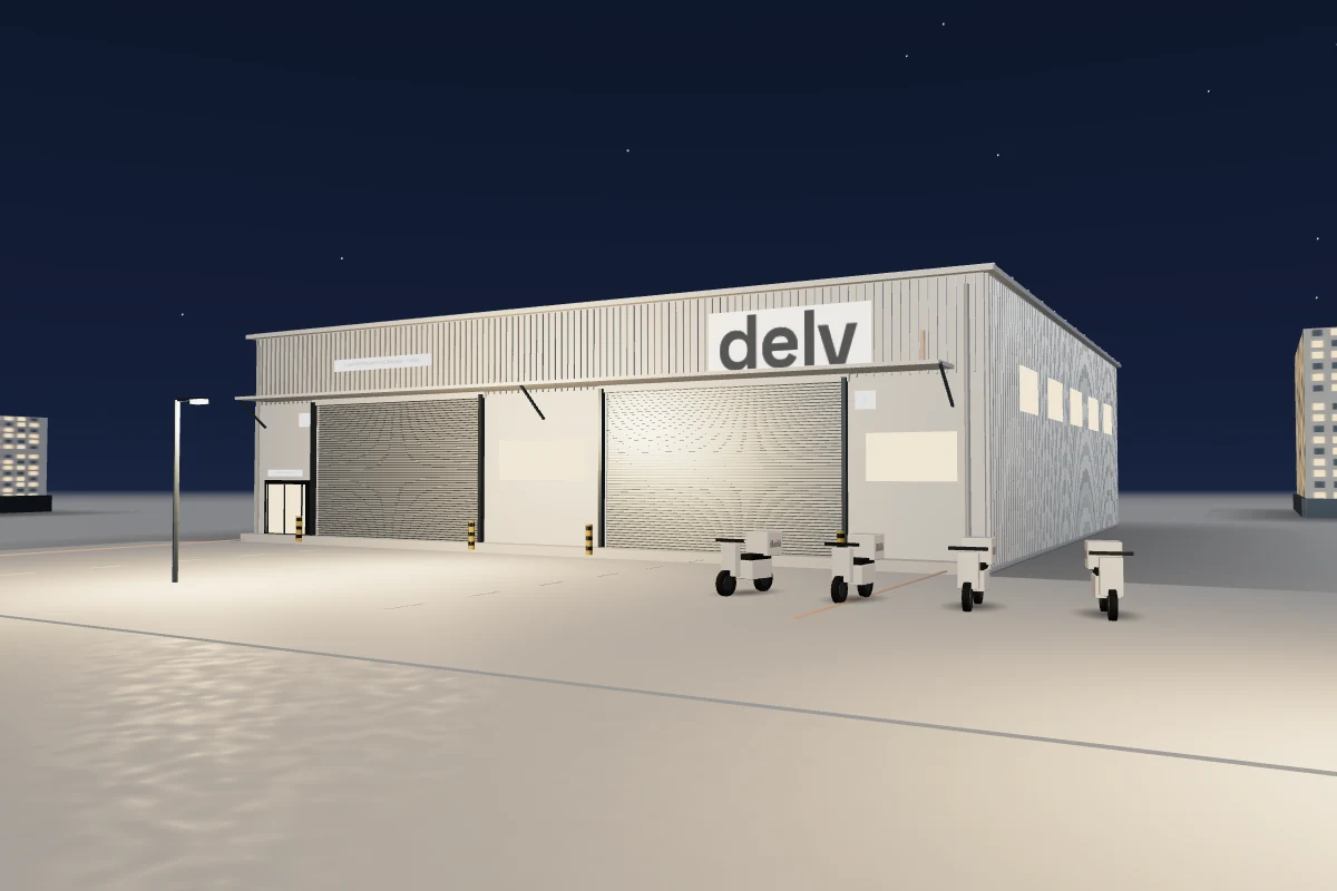 The Delv hub at night with lit windows, street lamps and scooters parked in the yard.
